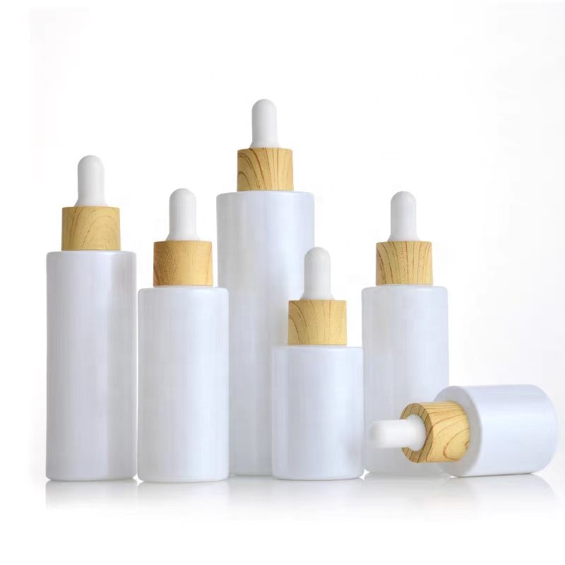 30ml 50ml 100ml Custom Pearl White Round Flat Shoulder Dropper Bottles Serum Glass Bottle With Wood Grain Cap for Essential Oil