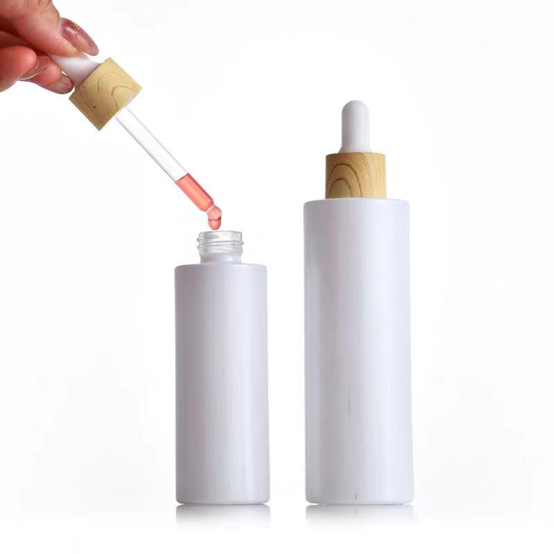 30ml 50ml 100ml Custom Pearl White Round Flat Shoulder Dropper Bottles Serum Glass Bottle With Wood Grain Cap for Essential Oil